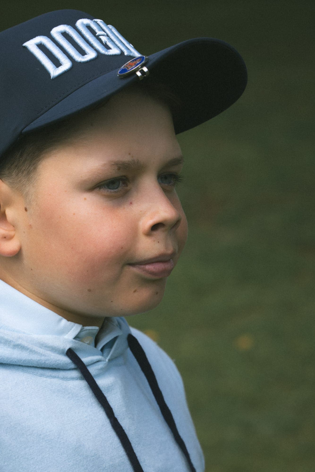 Young player in a Dogleg cap and hoodie